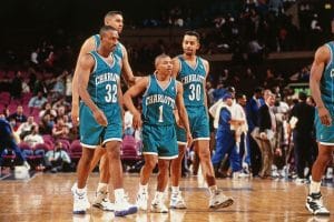 Four Charlotte Hornets players on the court during a basketball game