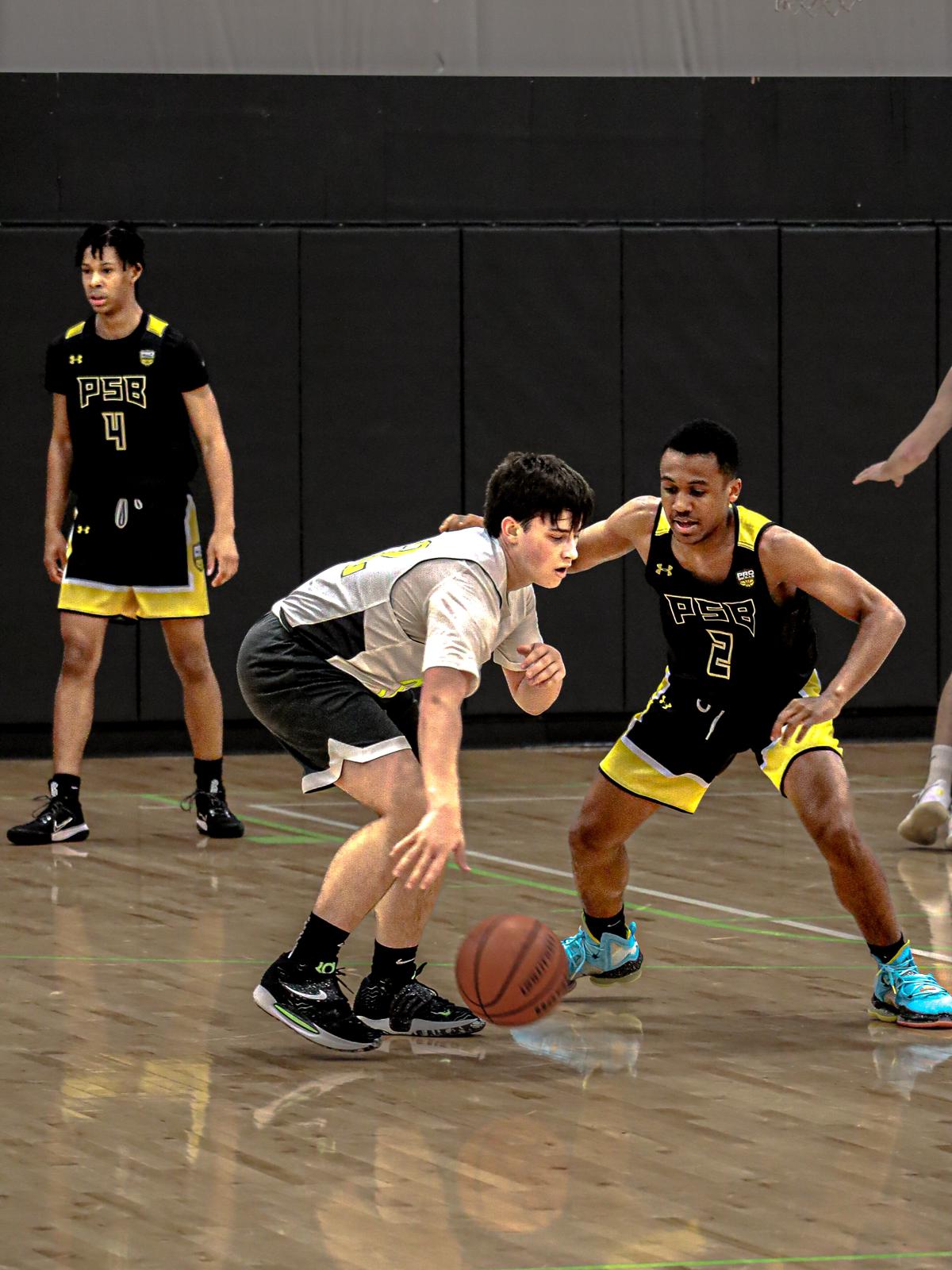 Youth Basketball Player dribbles past opponent during a Pro Skills Basketball game