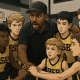 Youth basketball team huddling during game, showing unity and teamwork