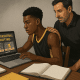 High school basketball player reviewing college recruiting materials with parent nearby, preparing highlight videos and emails.