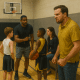 A lifelike painting of a youth basketball practice in an indoor gym: an athletic coach gives instruction to two boys holding a basketball, while an angry father clenches his fists and scowls from the sidelines and a concerned mother sits nearby.