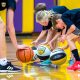 Children practice dribbling drills at a Pro Skills Basketball camp