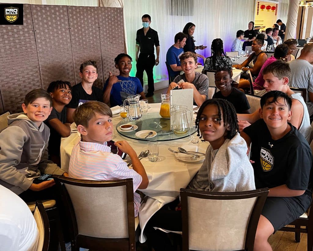 Youth Basketball team sitting at a dinner table in a restaurant