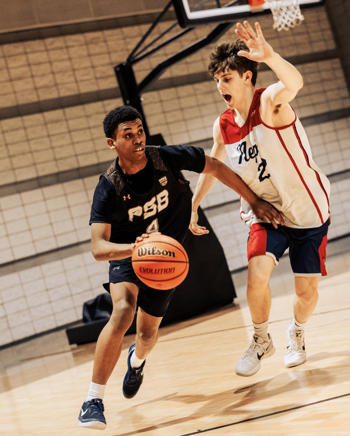 Youth basketball player driving to the basket in a tournament
