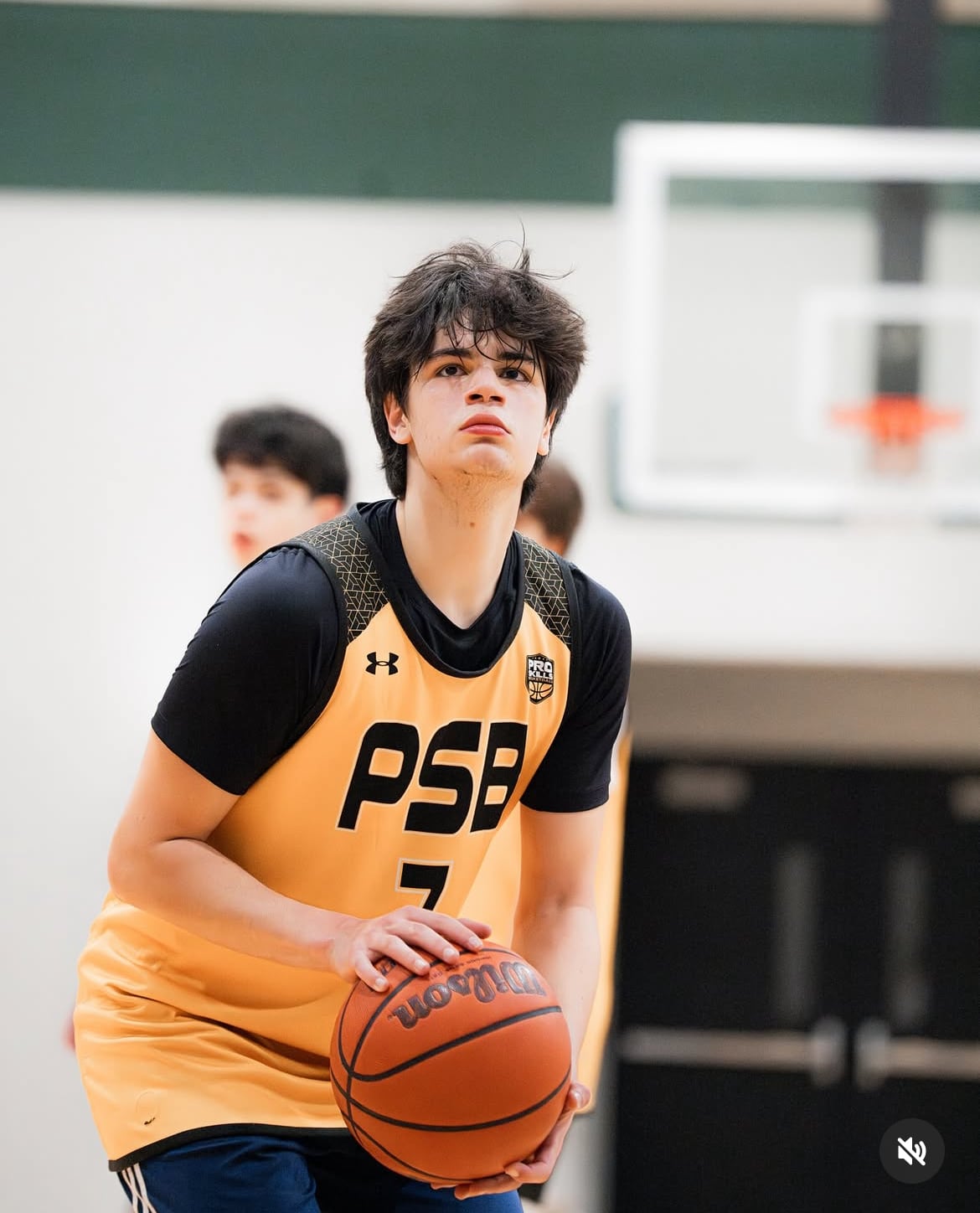 High school basketball player at the free throw line in a yellow PSB jersey
