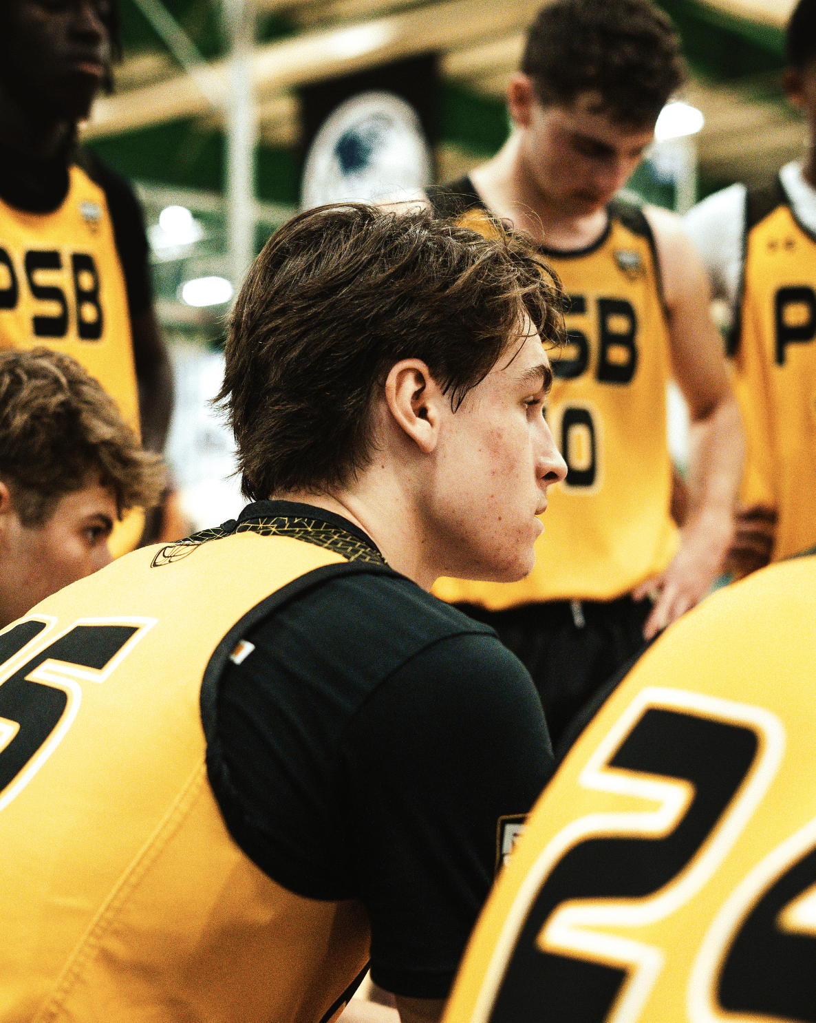 Youth basketball players in a team huddle at a Pro Skills Basketball camp