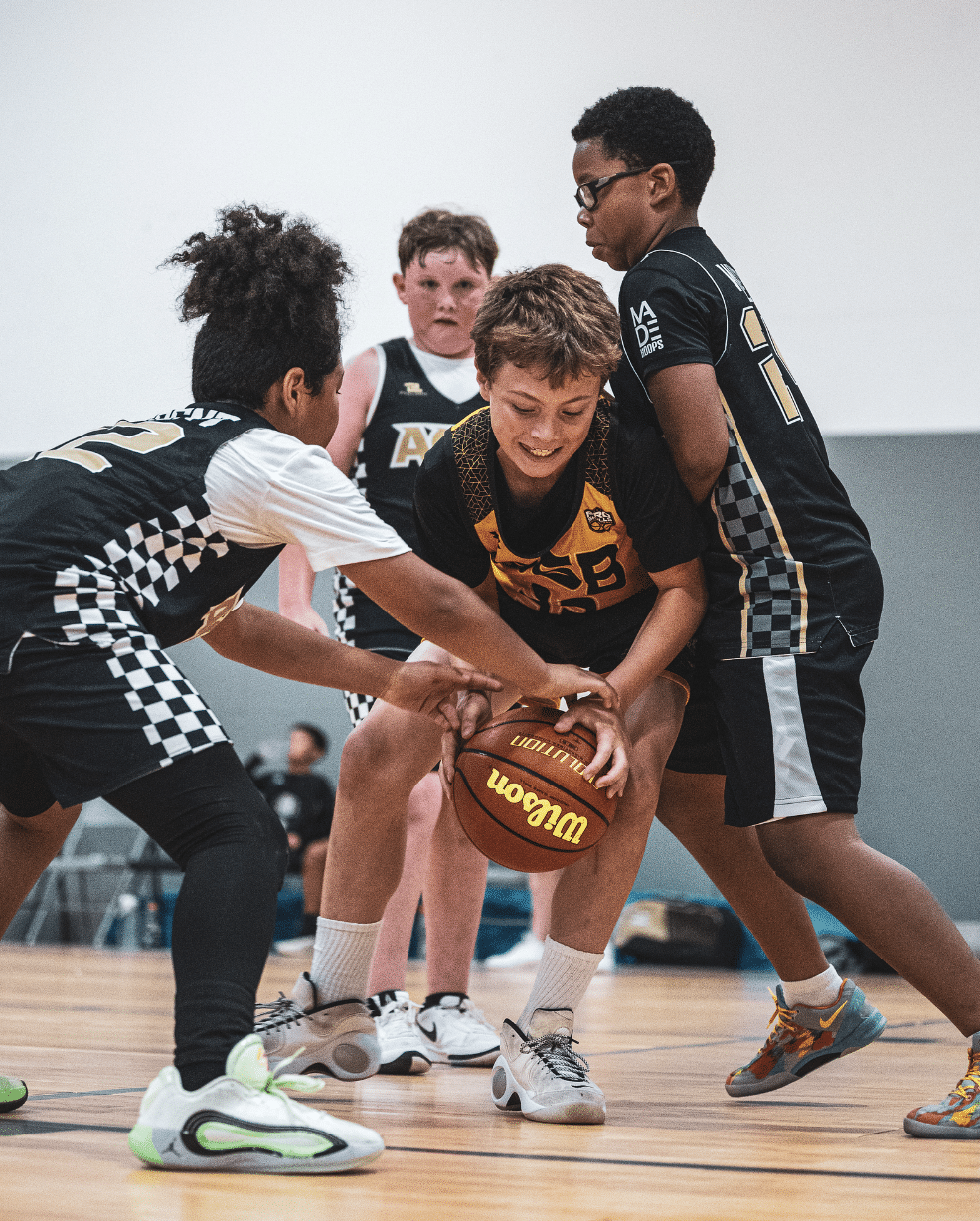 High school basketball players competing for a jump ball