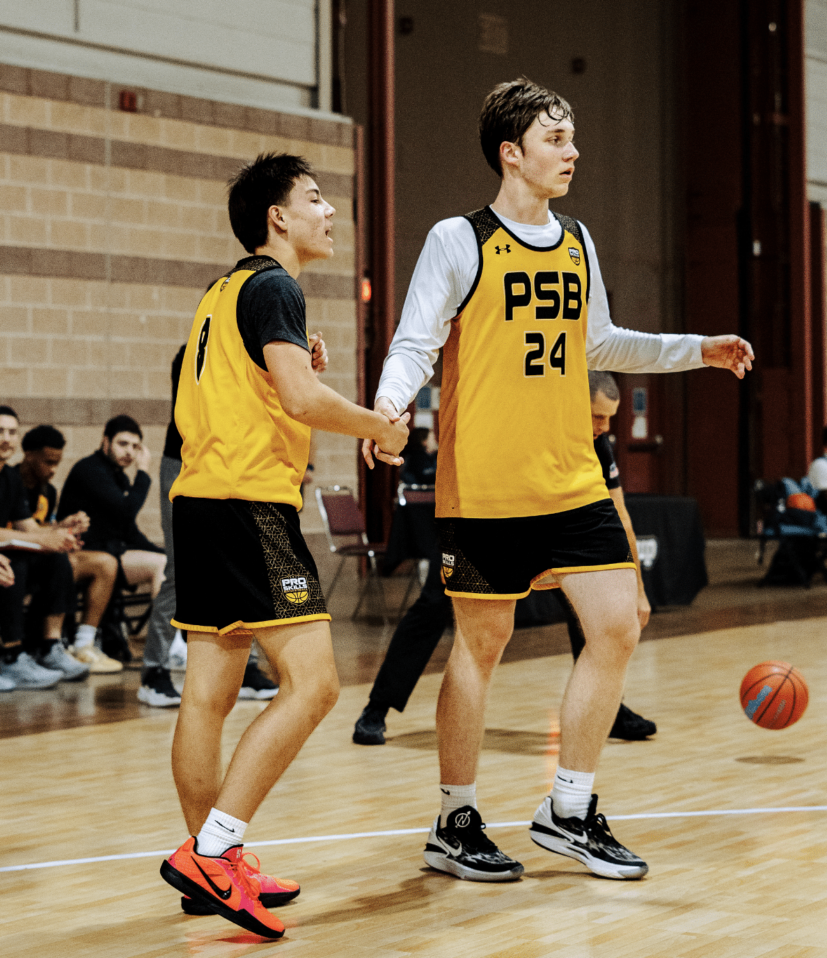 Two PSB basketball players sprinting in transition during AAU tournament showing the athleticism that basketball strength training builds