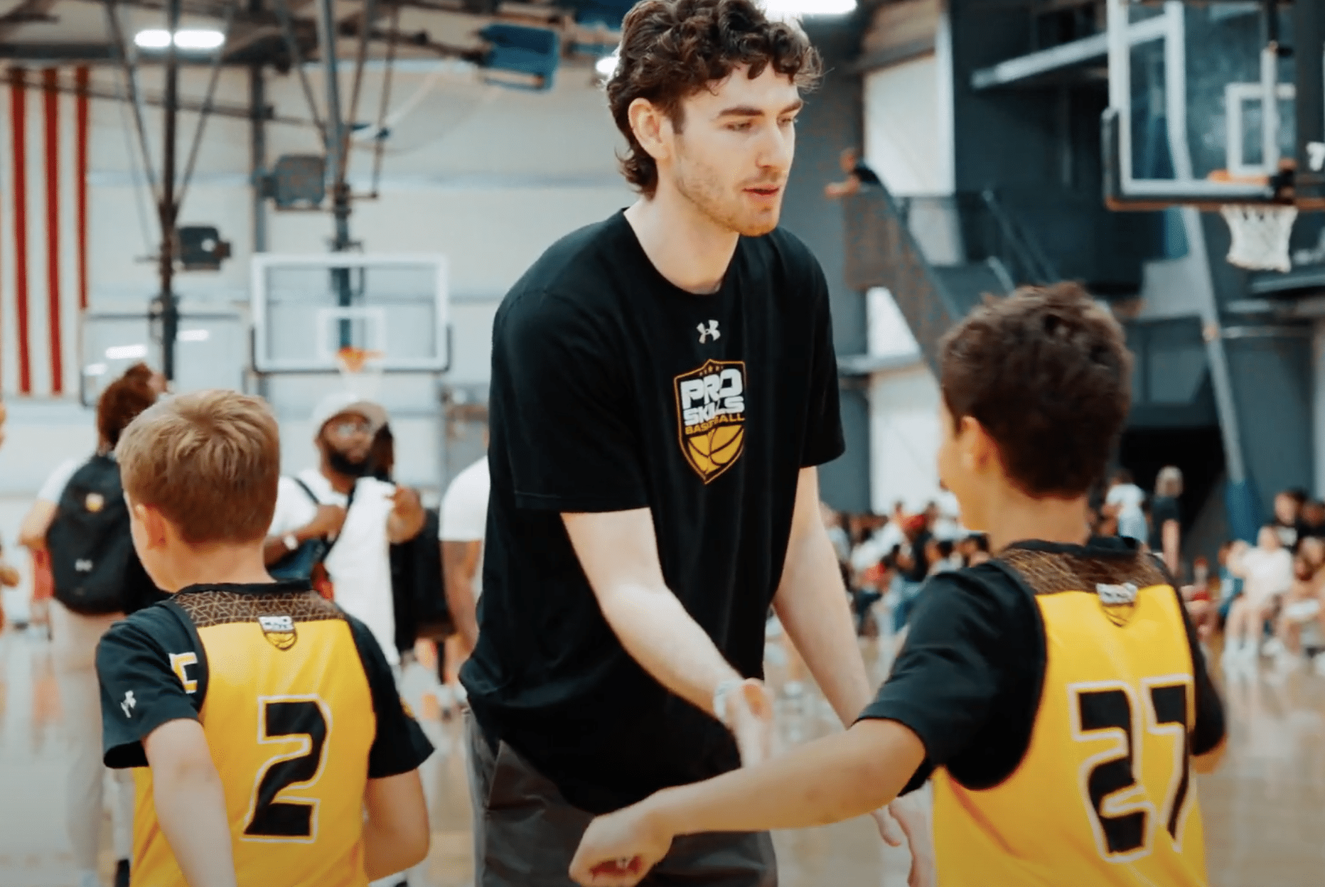 PSB coach shaking hands with a young basketball player