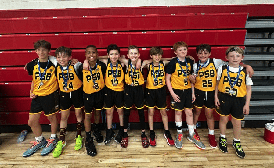 Youth basketball team lined up with their medals