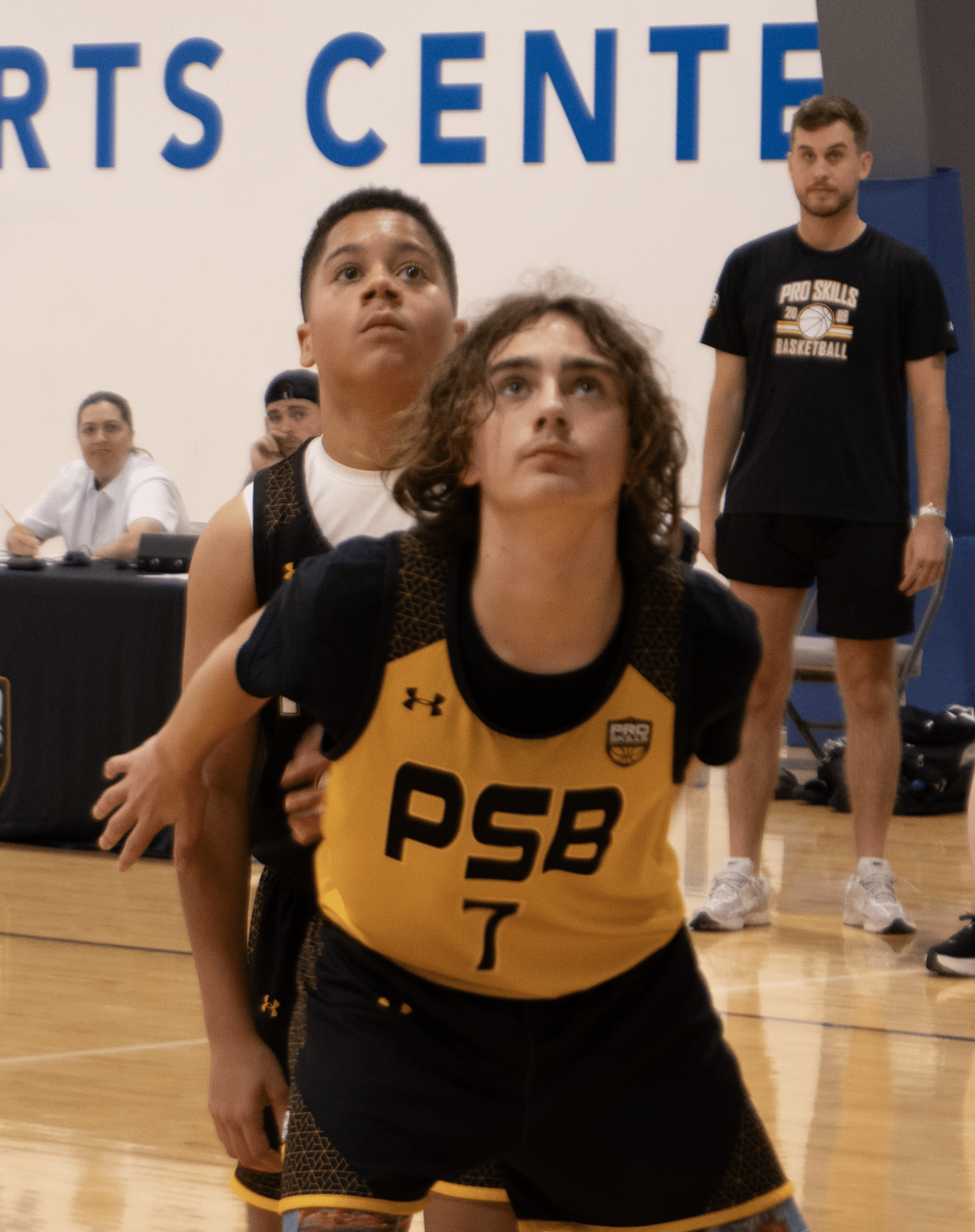 Youth basketball player boxing out during AAU game at sports center