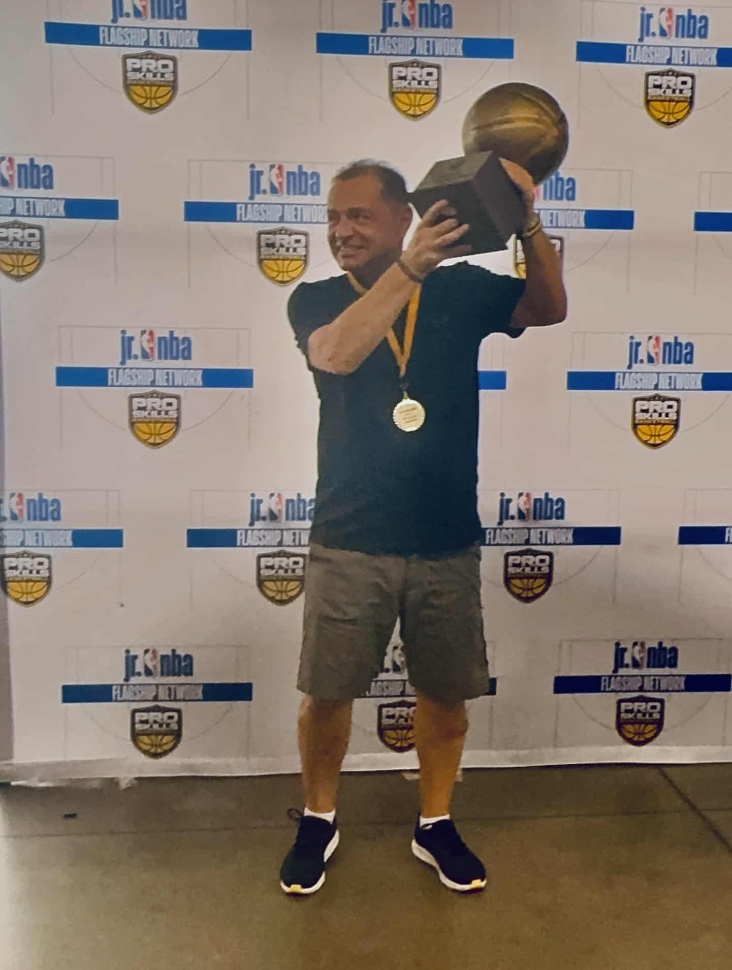 Coed Coach Holding Trophy Medal Jr Nba Backdrop