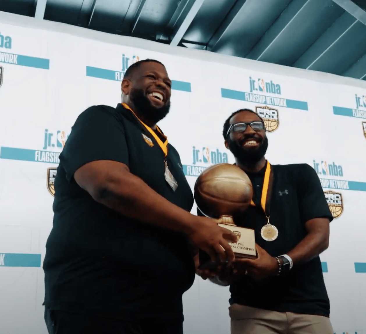 Pro Skills Basketball coaches with trophy at Jr. NBA youth basketball event
