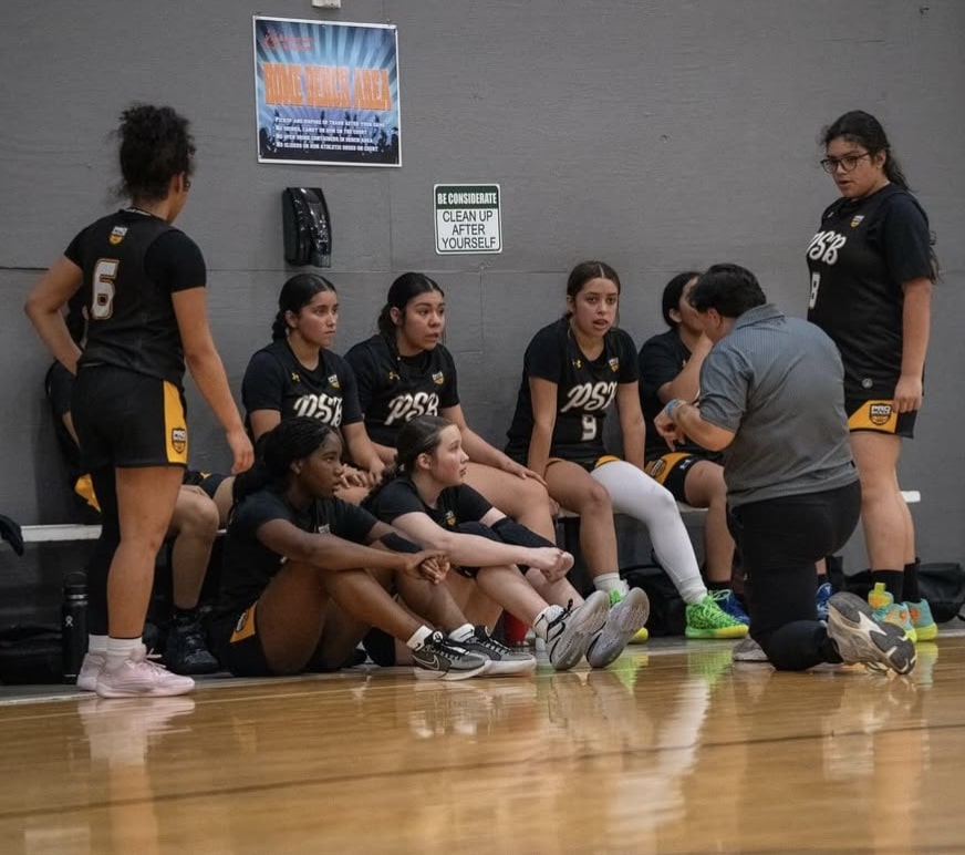 Players talking with their coach on the sideline