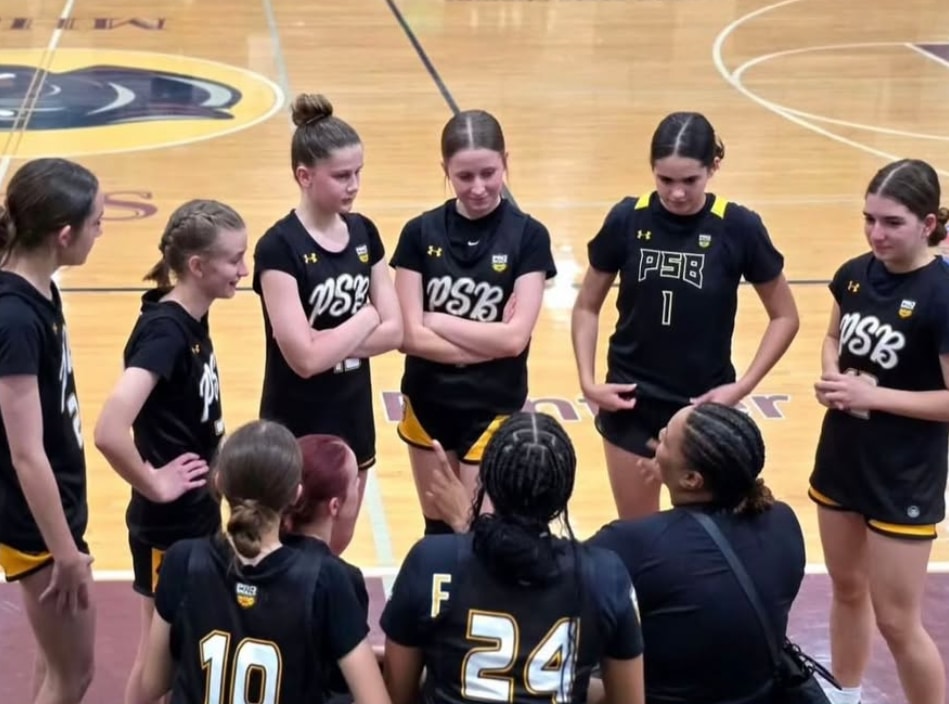 Youth basketball players competing in a close game