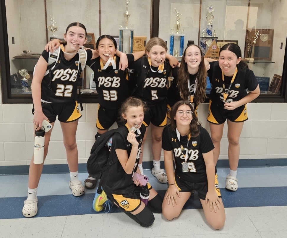 Youth basketball players celebrating with medals at a tournament