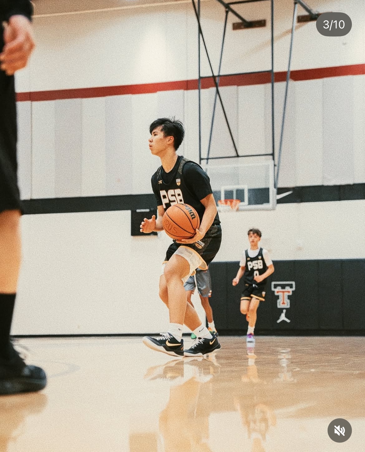 Youth basketball coach huddling with young players during a tournament