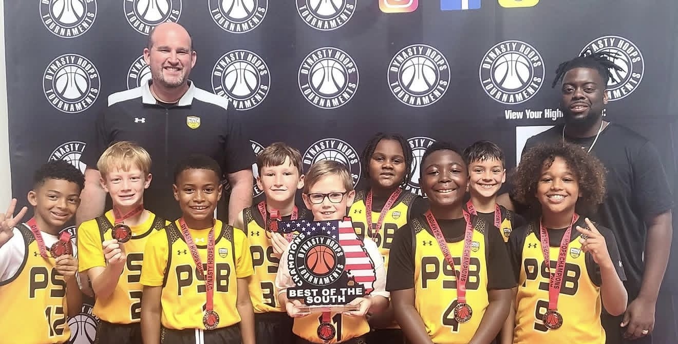 A 3rd grade club basketball team with medals and coaches after a tournament
