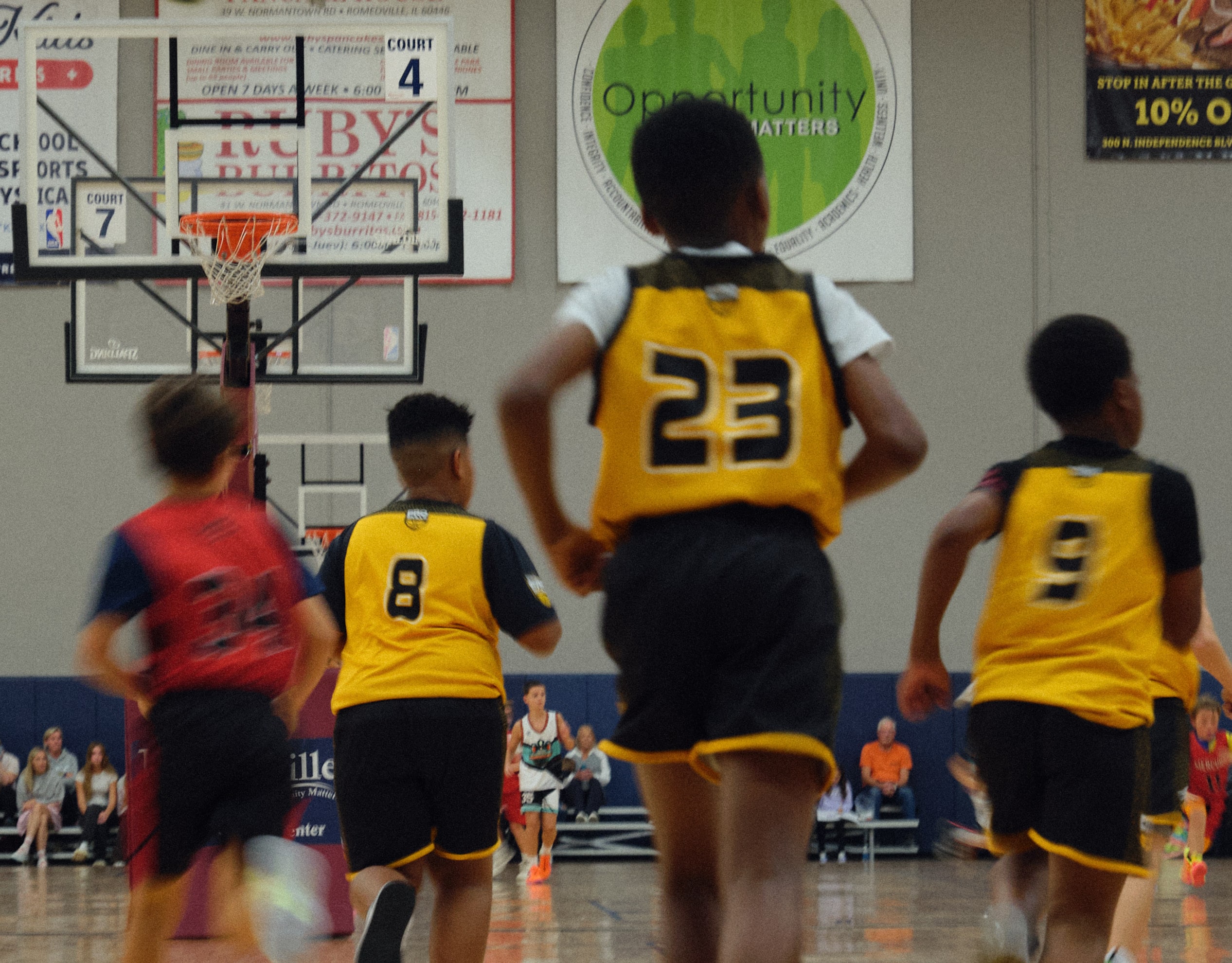 Youth basketball player handling the ball along the baseline