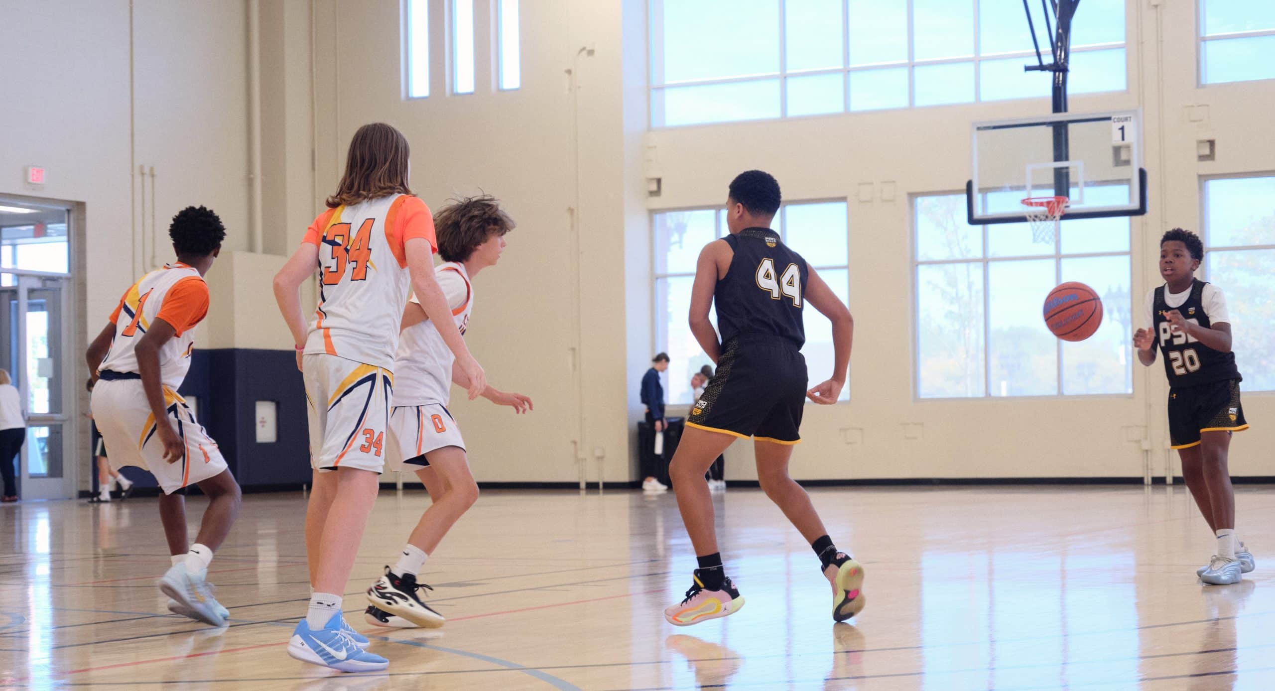 Youth basketball player defending in transition