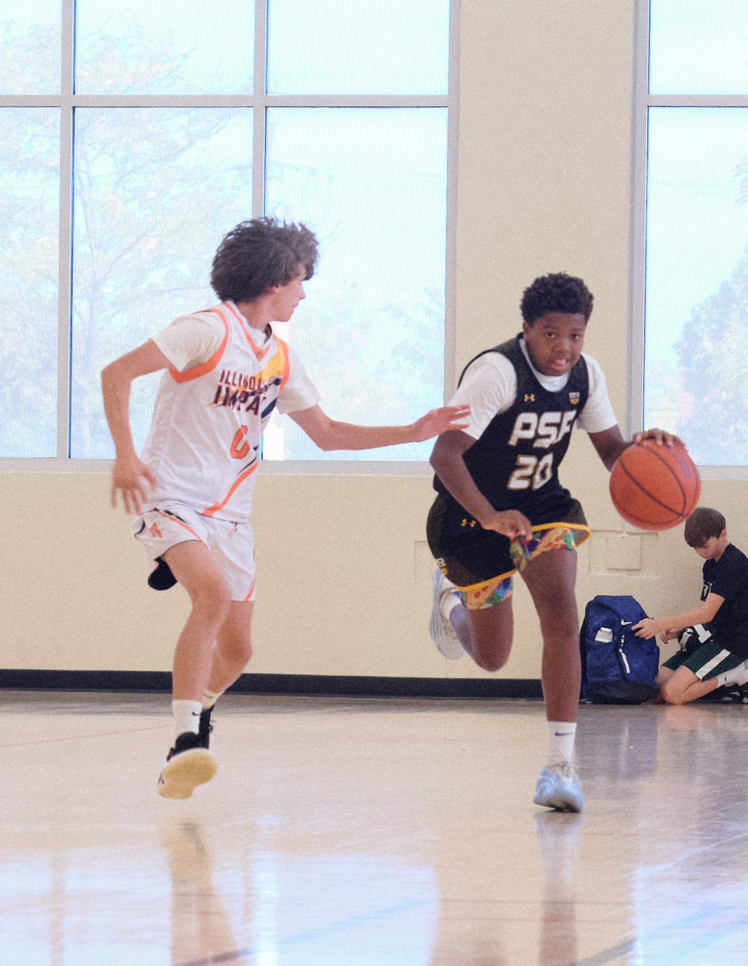 High school basketball player driving to the basket