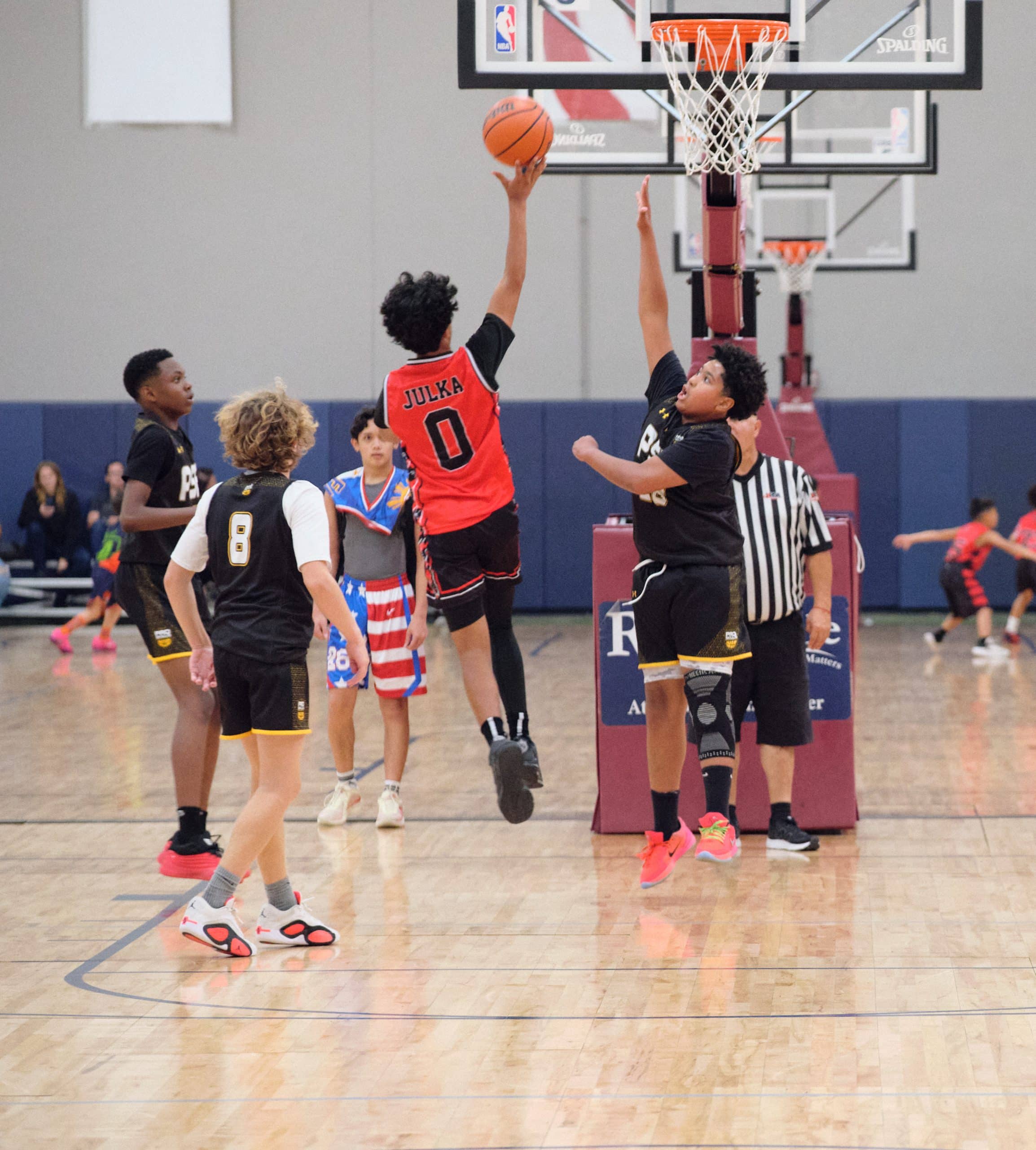 Basketball game action on a full court
