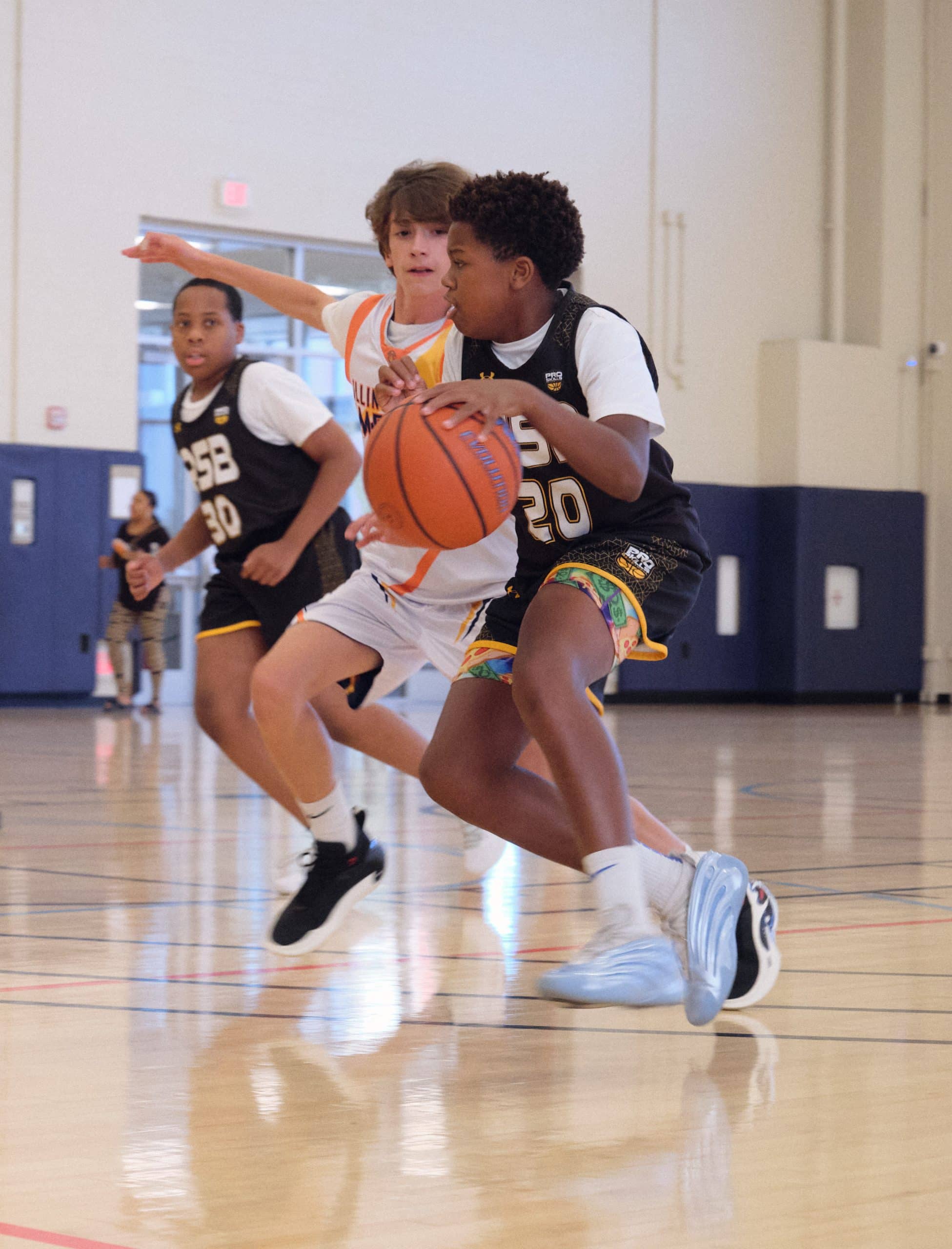 Youth basketball players battling for a loose ball