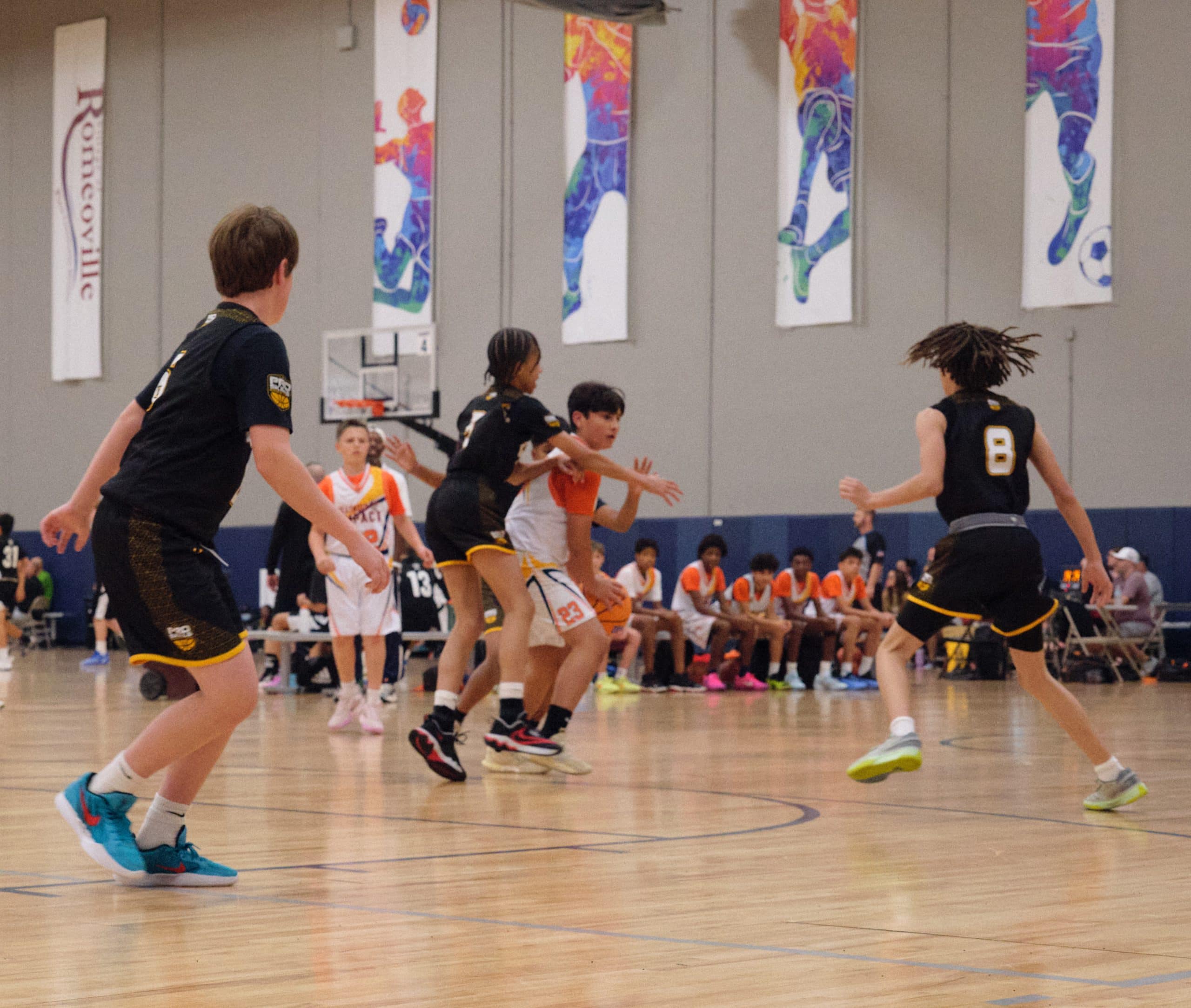 Defender guarding a ball handler in a high school game