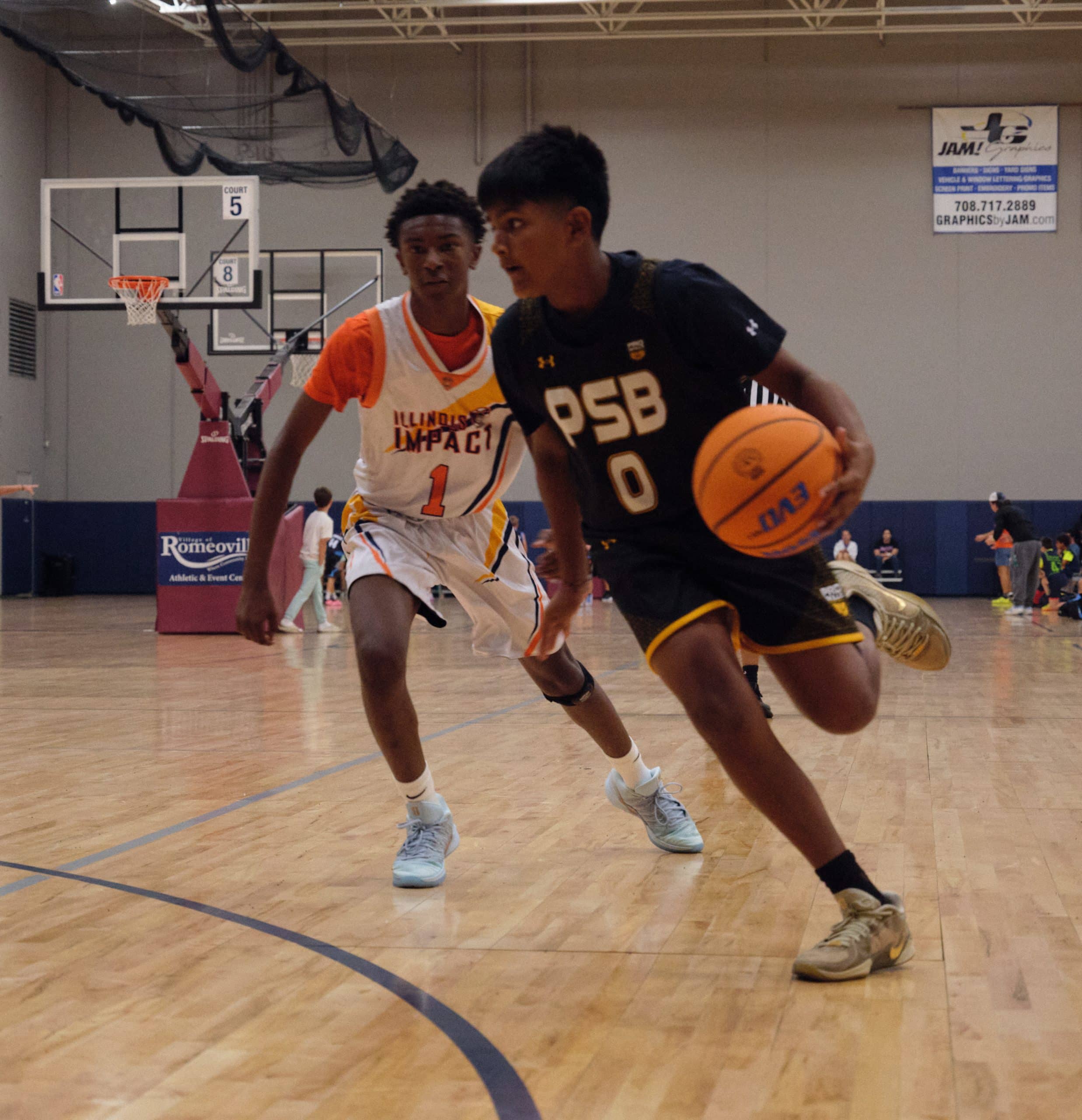 High school basketball player driving to the basket in a game