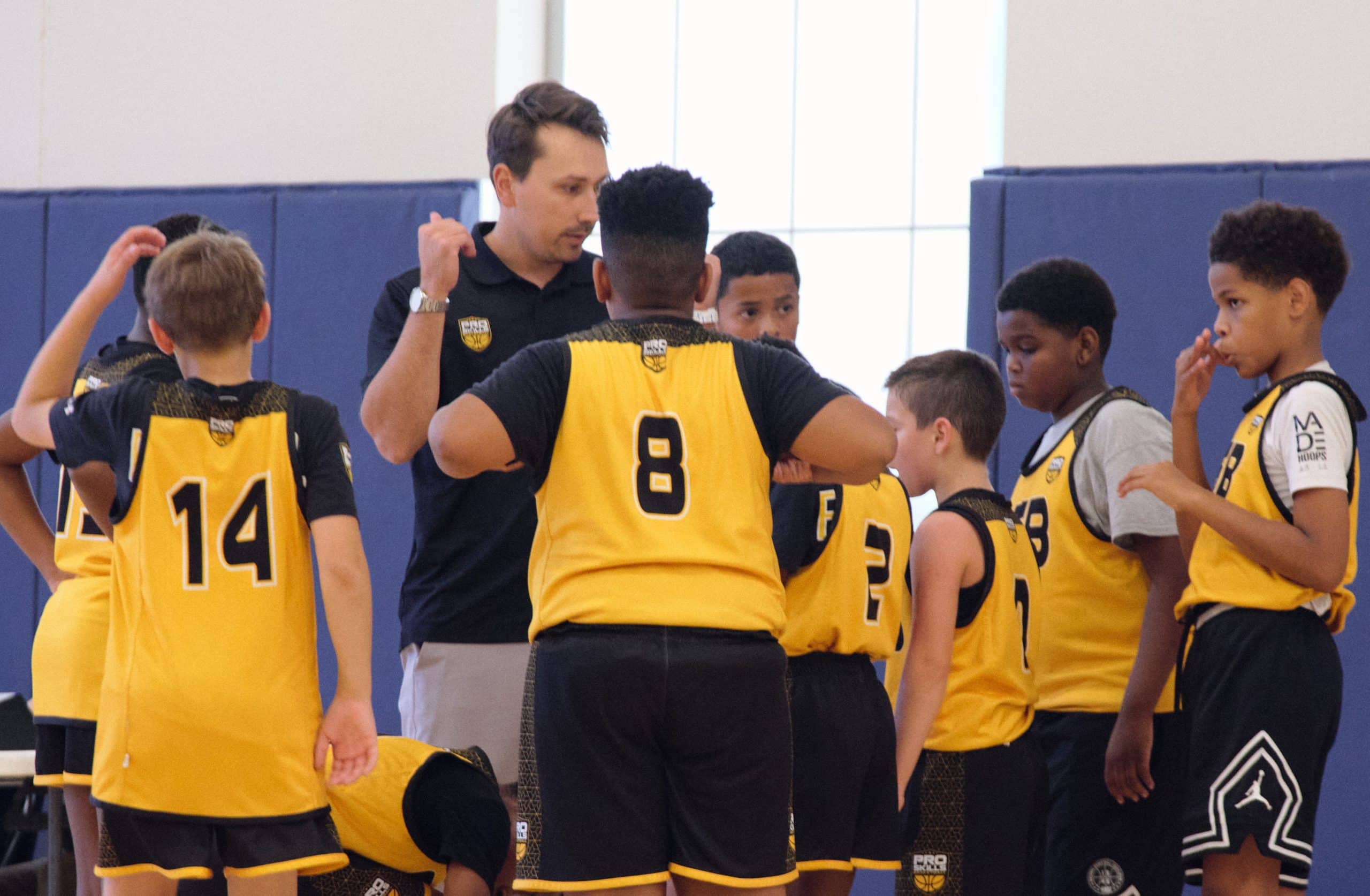 Youth basketball team in a coach huddle during a game