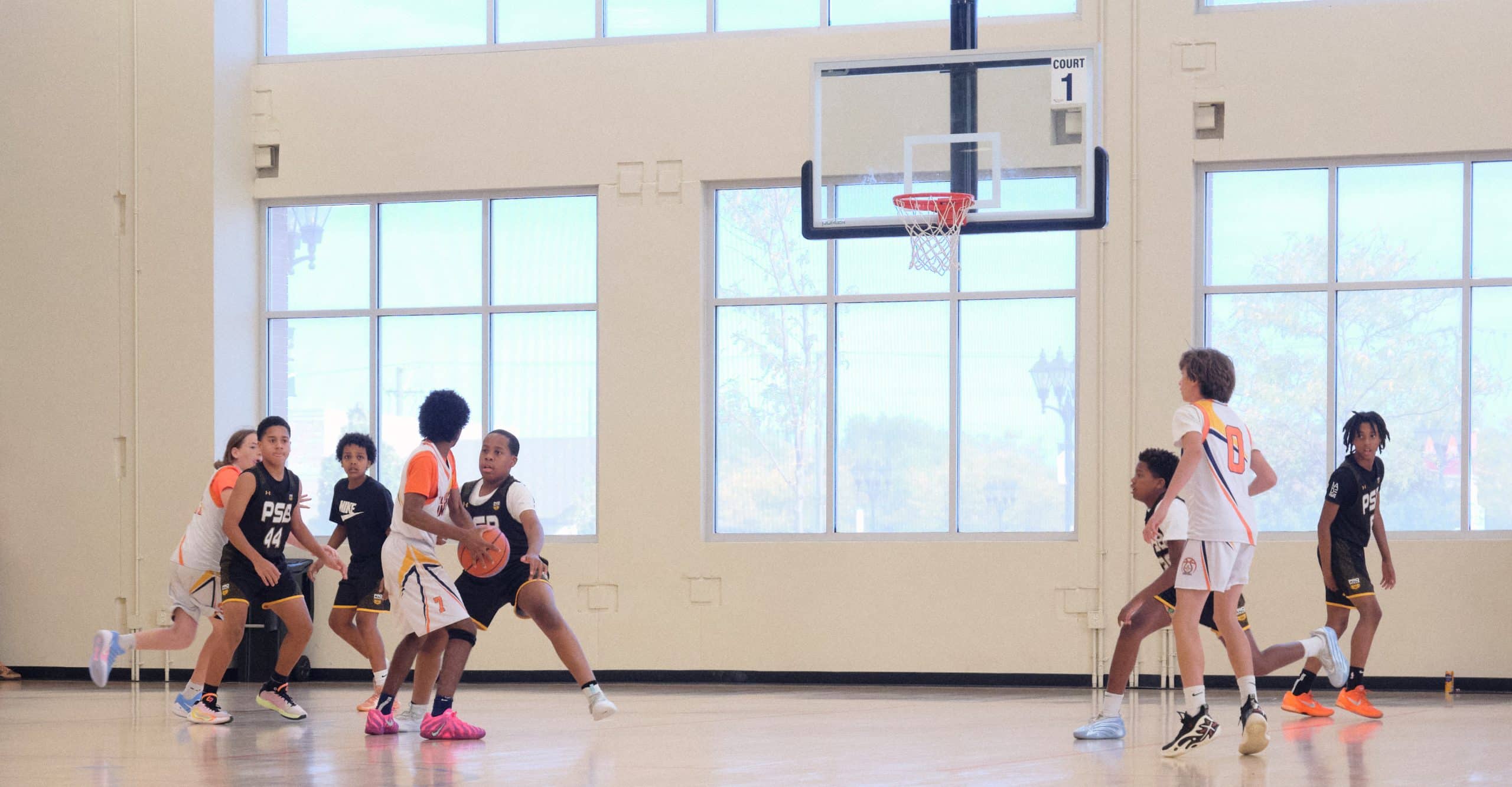 Youth basketball players in baseline game action