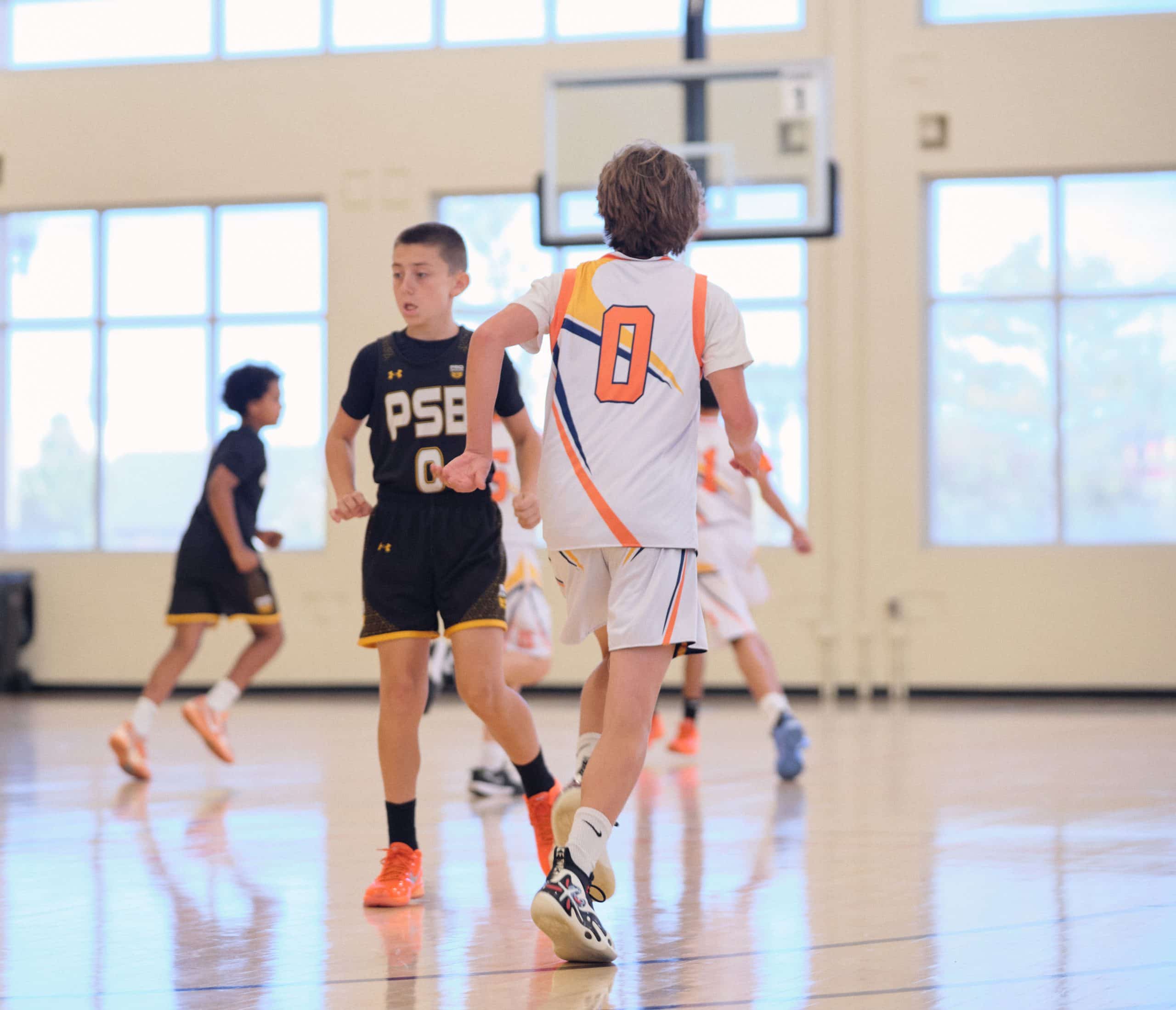 Youth basketball team moving in transition during a game