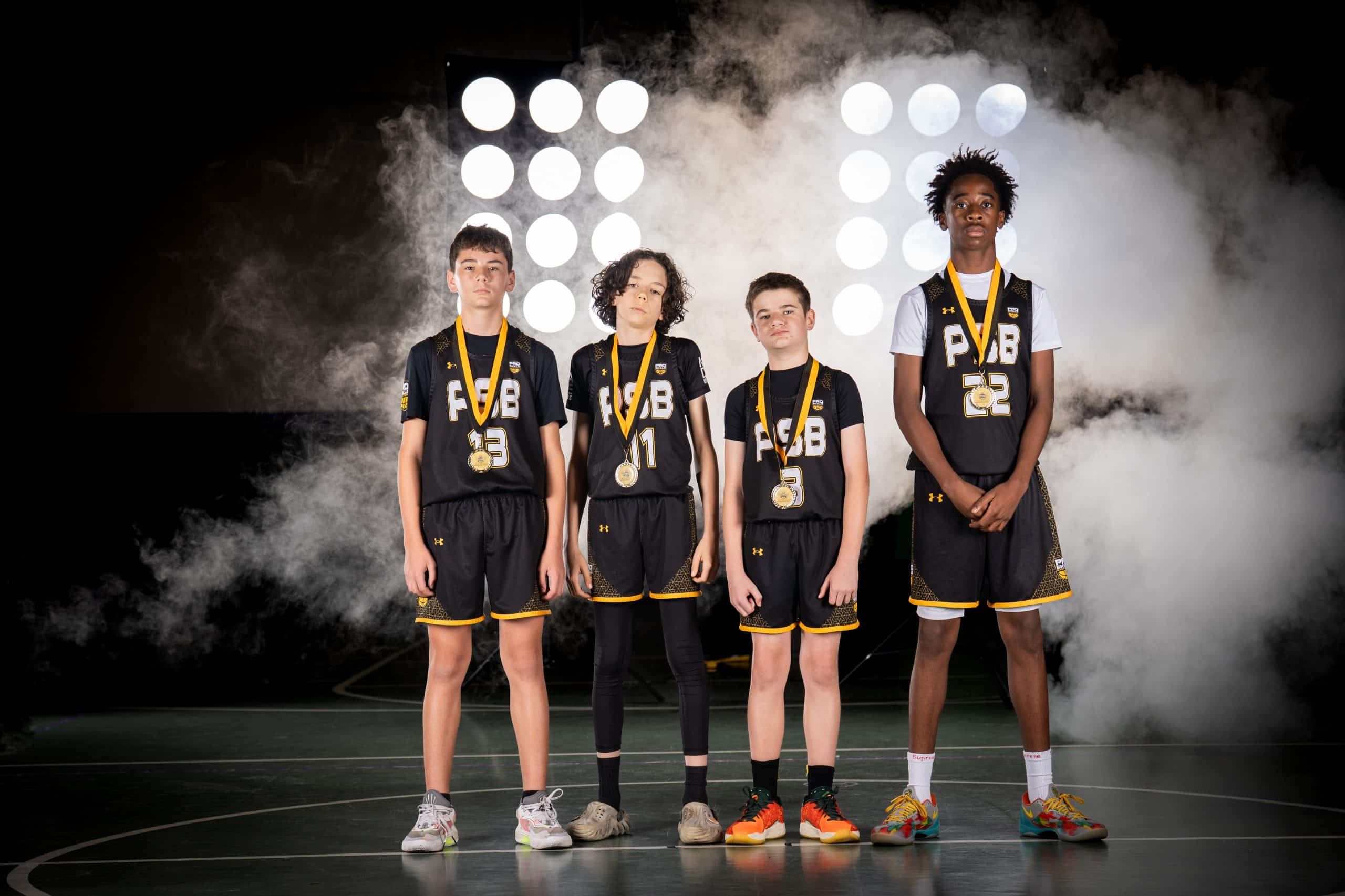 Youth basketball players celebrating with medals