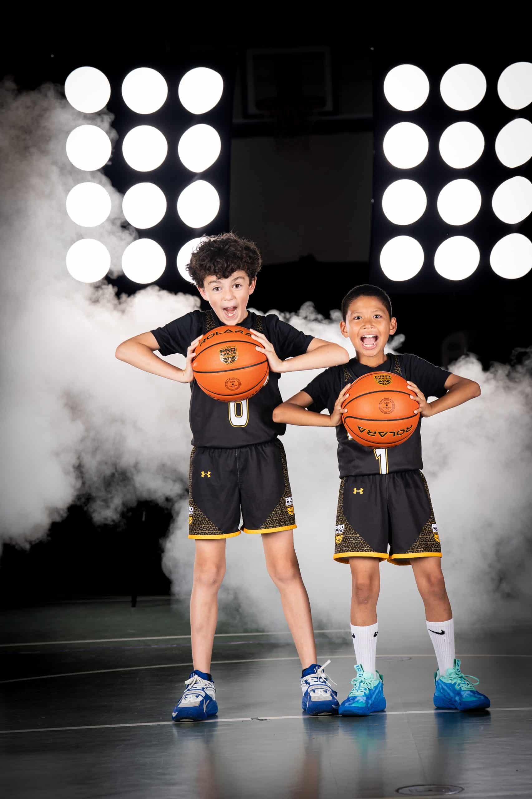 Youth basketball players posing with basketballs