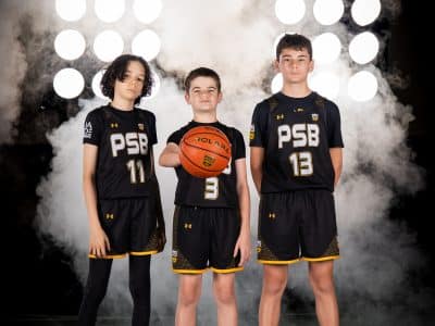 Three PSB players posing with a basketball