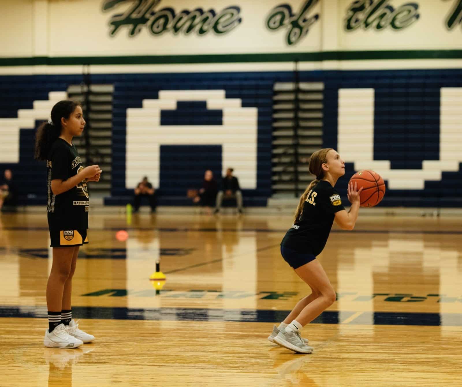 Youth basketball player in a shooting stance at a PSB clinic