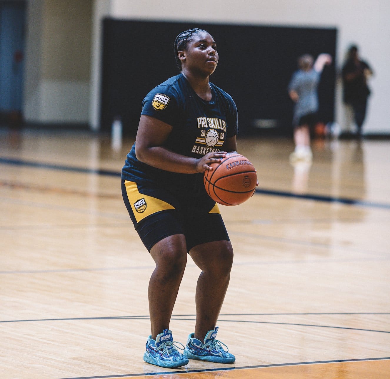 Youth basketball player in a free throw stance at a skills clinic